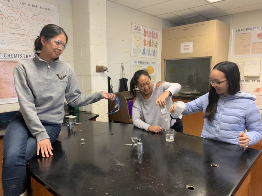 Grace, Angelina, and Julia pose for a photo contest on the SMCS M&M Cup Twitter page. The threesome simulate a laboratory experiment scenario.