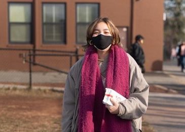 Caitlyn Fanelli leads students to the field to protest ineffective COVID policy enforcement.