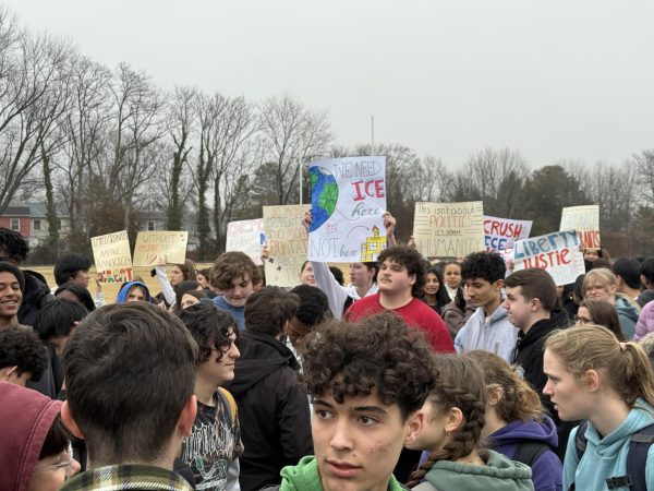 Students hold up posters to express their concerns.